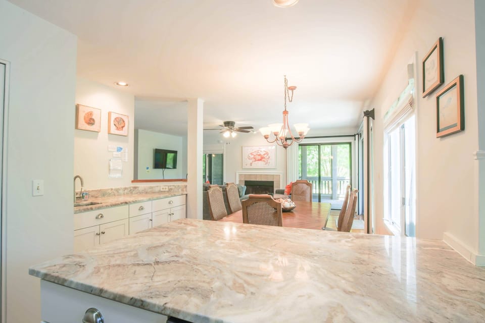 This home receives lovely natural light through its many windows and sliding glass doors.