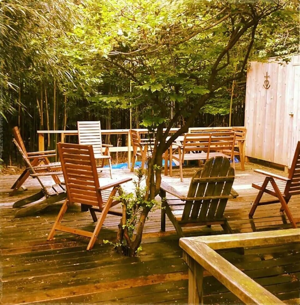 Back deck with sun and shade seating, kids' toys and a 2nd picnic table