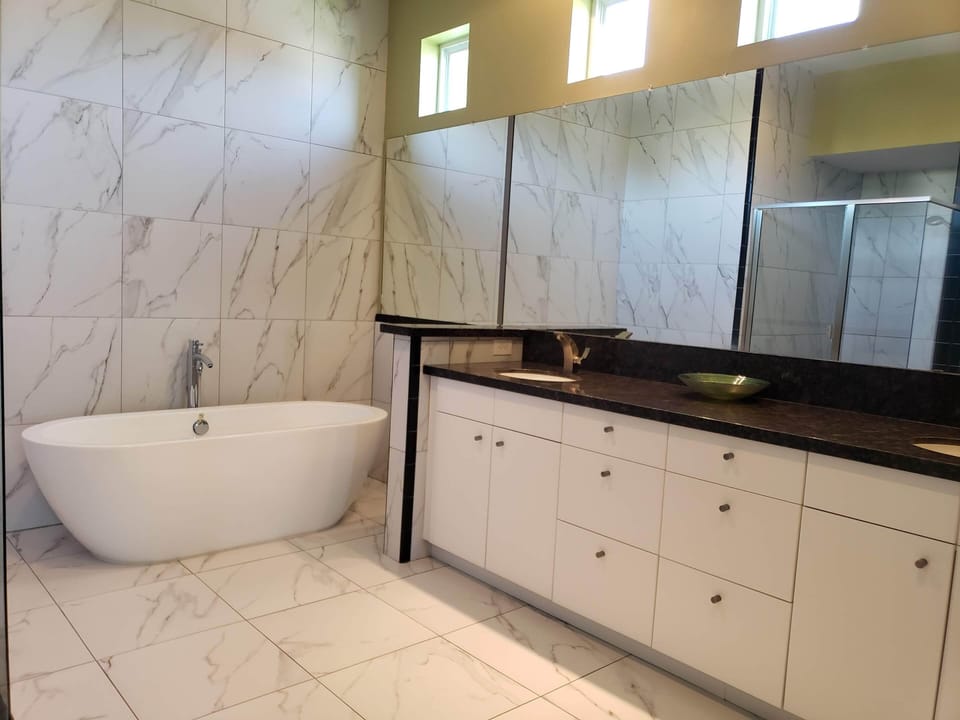 A large Master Bathroom with a tub
