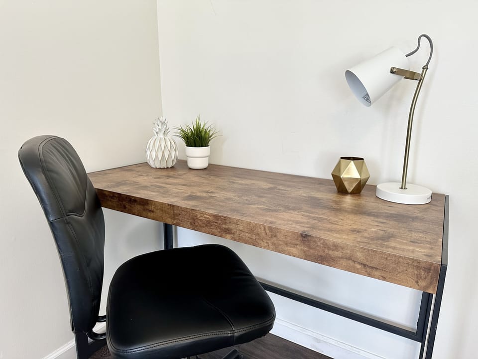 Large office desk with comfy chair.
