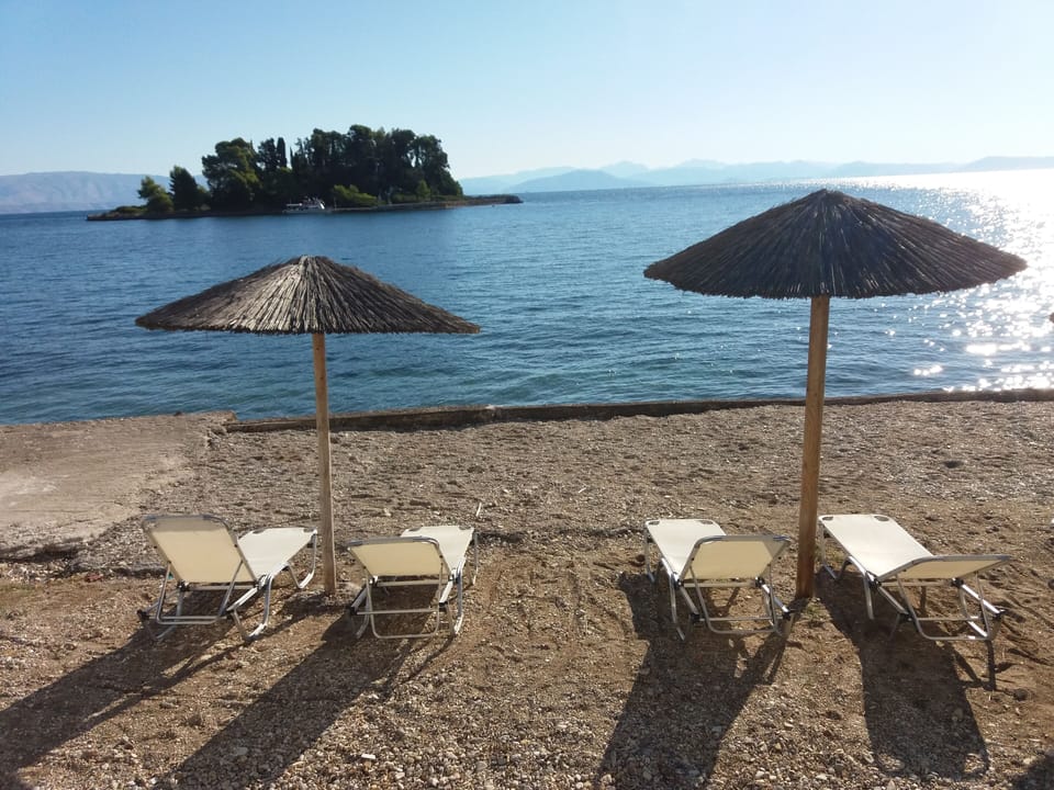 Aegli Hotel`s beach with umbrellas