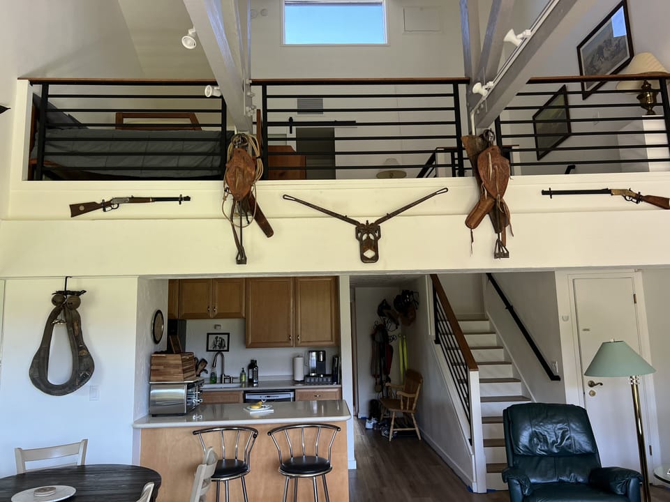 Larger view of the loft and kitchen. Rifles are replicas.