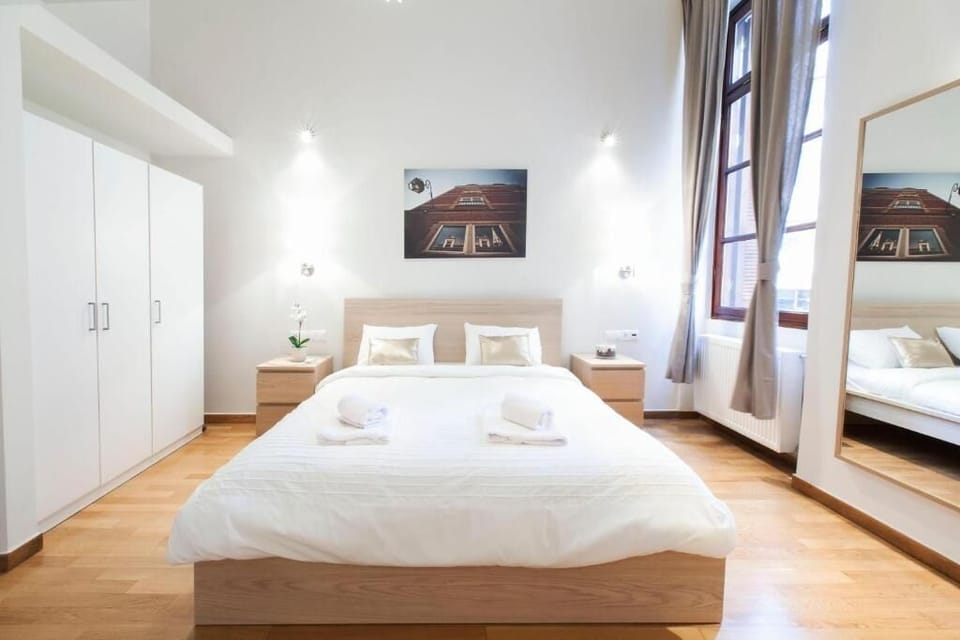 Spacious, comfortable bedroom with king-sized bed and wardrobe.