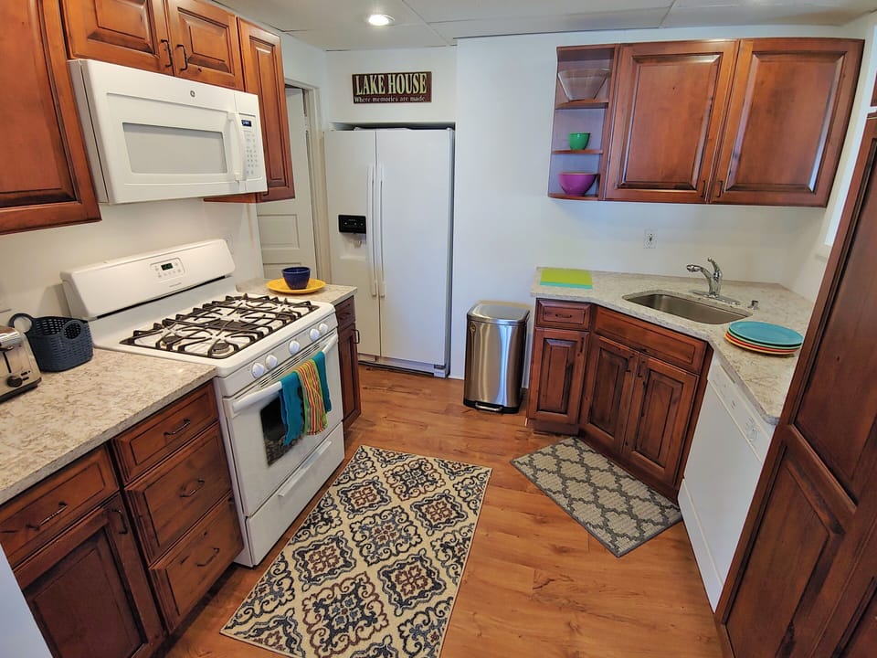 Stocked kitchen with cookware, dishes, coffee pot, fridge w icemaker, etc.
