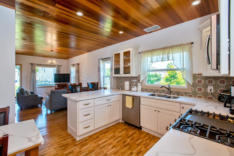 Kitchen showing living room, large windows and red cedar wood ceiling & internet