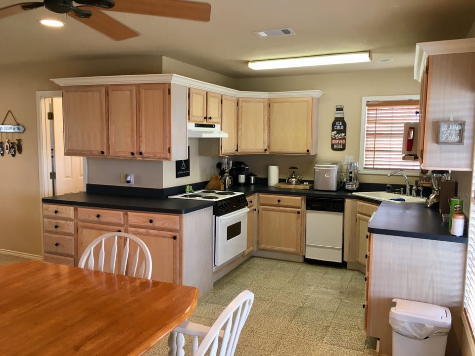 Kitchen and dining area. Fridge is small with no freezer. Counter top ice maker.