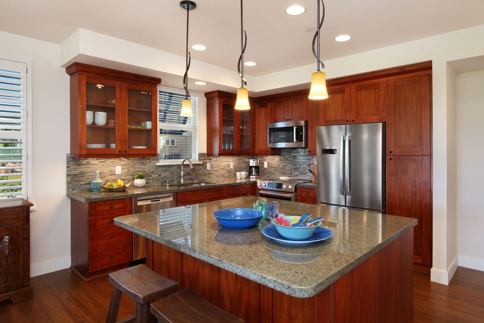 Modern, chef-ready kitchen with high-end appliances and granite countertops—perfect for preparing island-inspired meals.