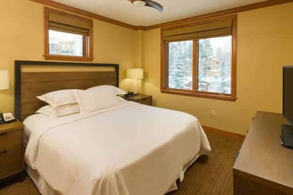 Master bedroom has king bed with luxury linens