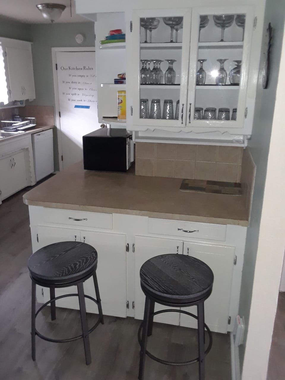 Kitchen area with glass cabinet.