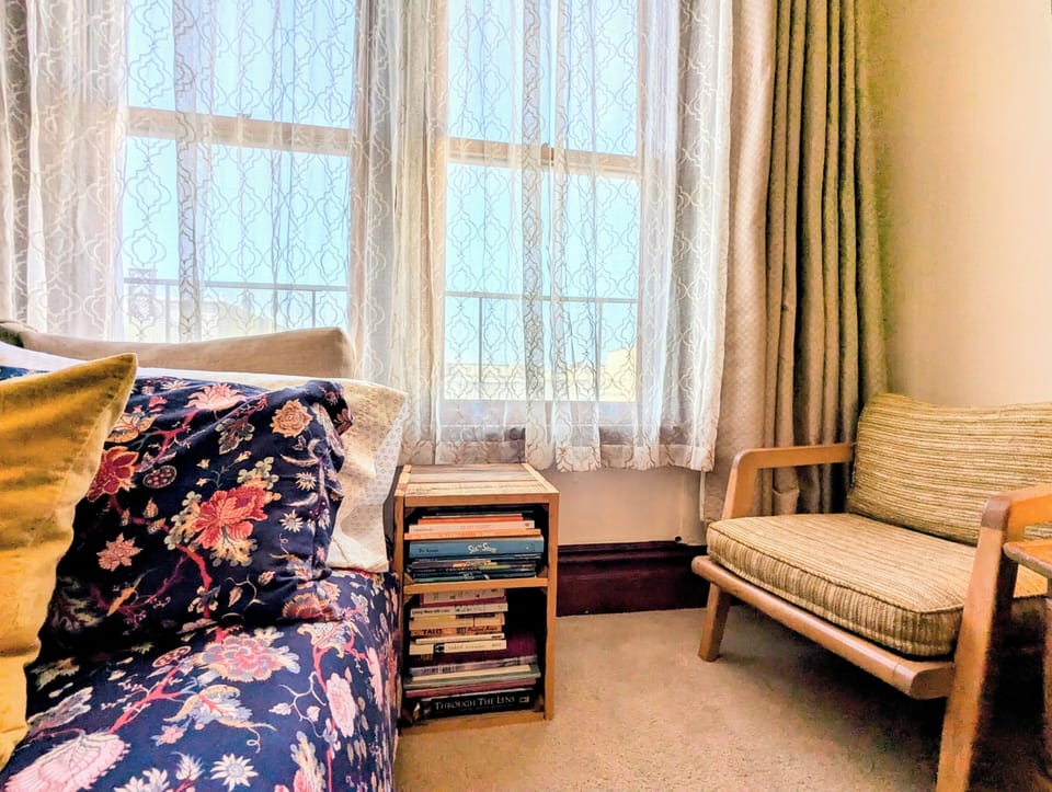 Room 1 includes mid-century chairs in addition to the couch/sofabed.