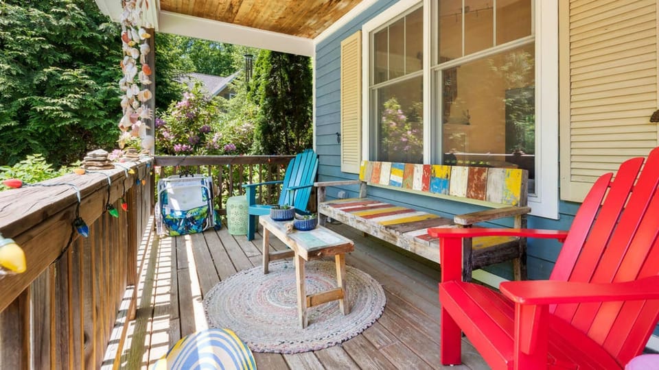 Covered deck with seating and garden views