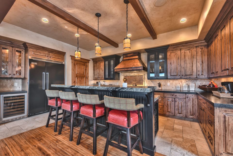 Chefs Kitchen with Stunning Cabinetry, Granite Counters, and Island/Bar with Seating for 4