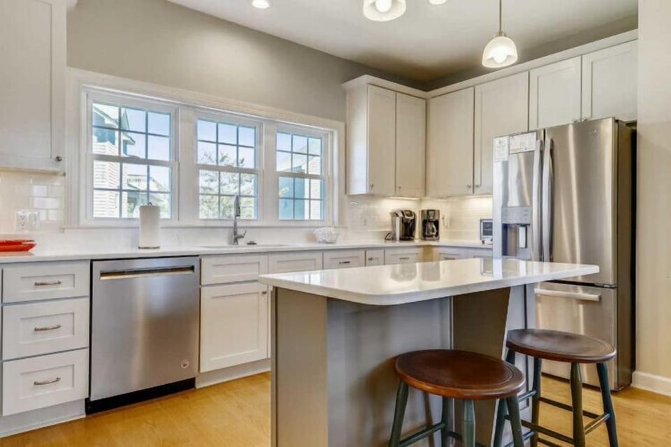 Step into your bright, fully-equipped kitchen with sleek stainless steel appliances, a spacious island for meal prep, and plenty of storage for everything you need during your stay.