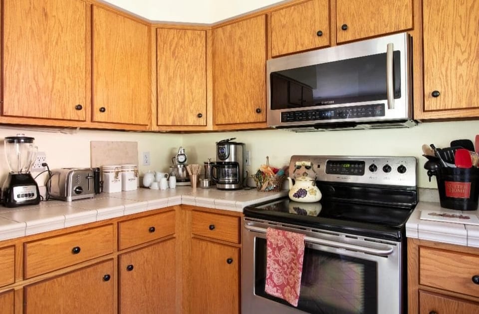 Porteion of Kitchen with Small Appliances. Shelving holdss an aray of essentials