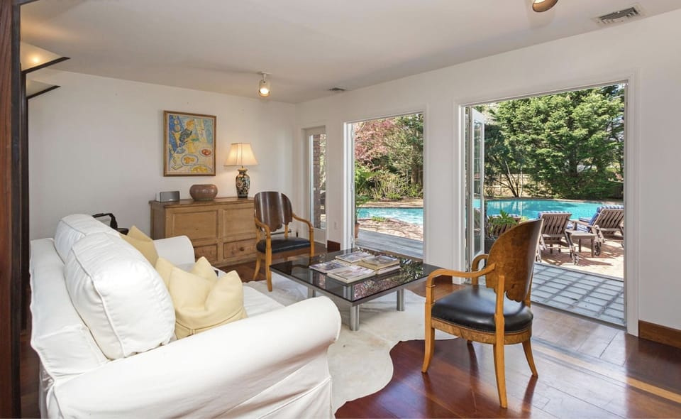 Living room area opens to pool patio via out swing French doors