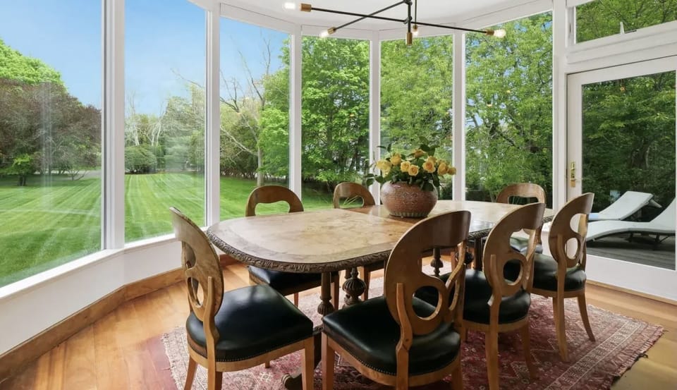 Dining room with large windows (electric shades for coverage)