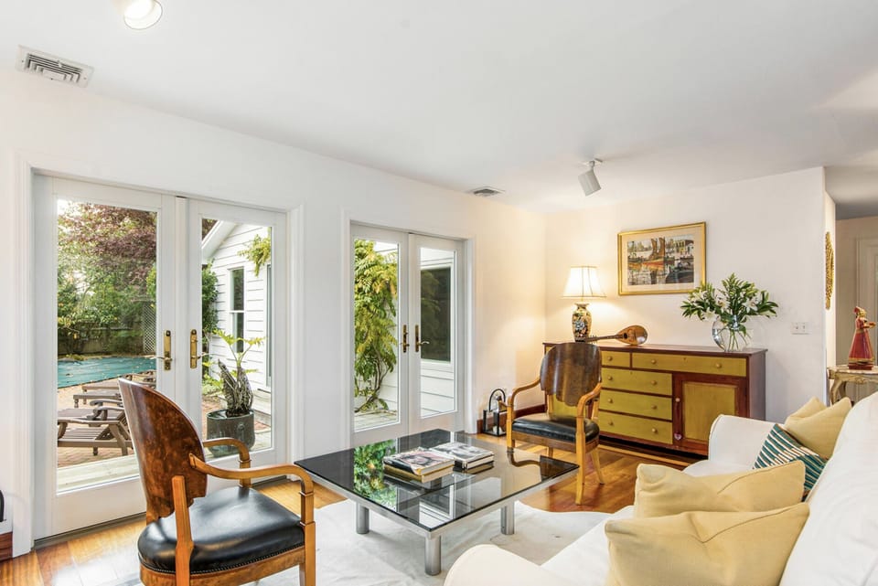 Living room area opens to pool patio via out swing French doors