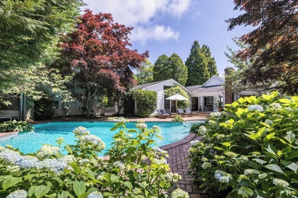 View from far side of enclosed private pool area looking at house