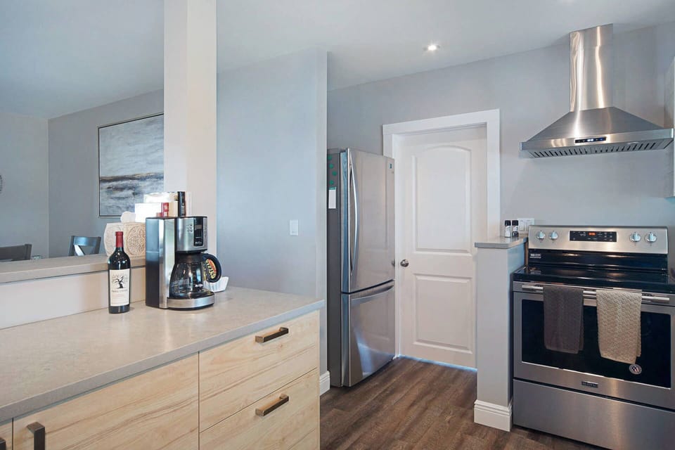 Kitchen view with island on left, looking through towards dining area