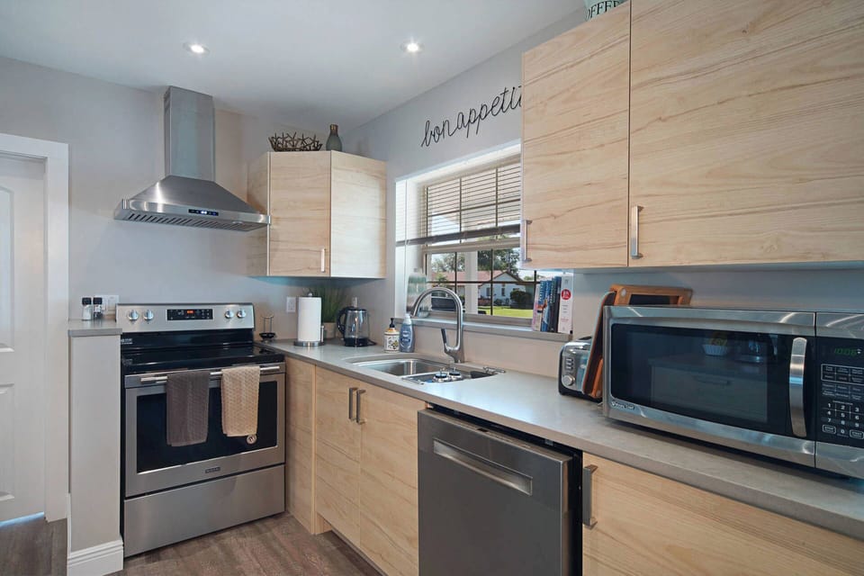 Brand-new kitchen with quartz countertops and stainless steel appliances