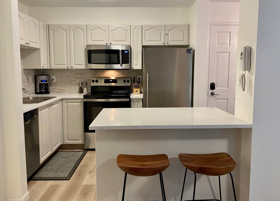 Kitchen with quartz countertops and breakfast bar.