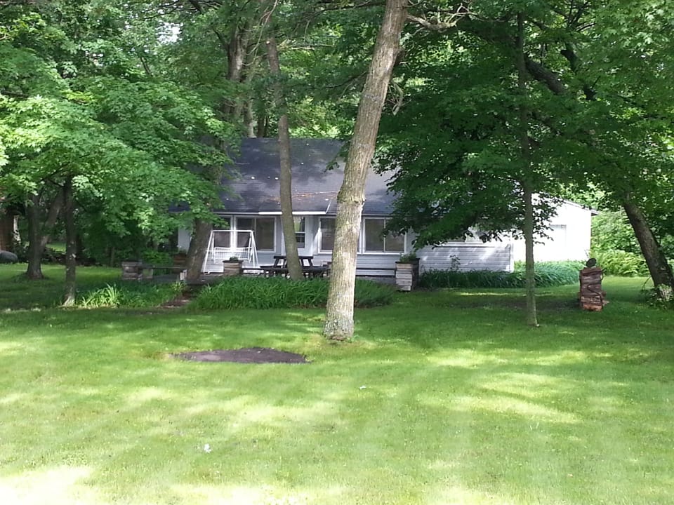 Front view of the cabin and yard with lots of room for yard games. Huge deck