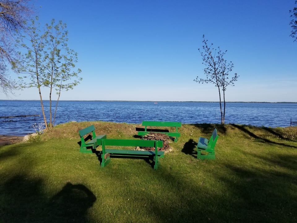 Our lakeside fire ring with comfortable  benches ready for your campfire 