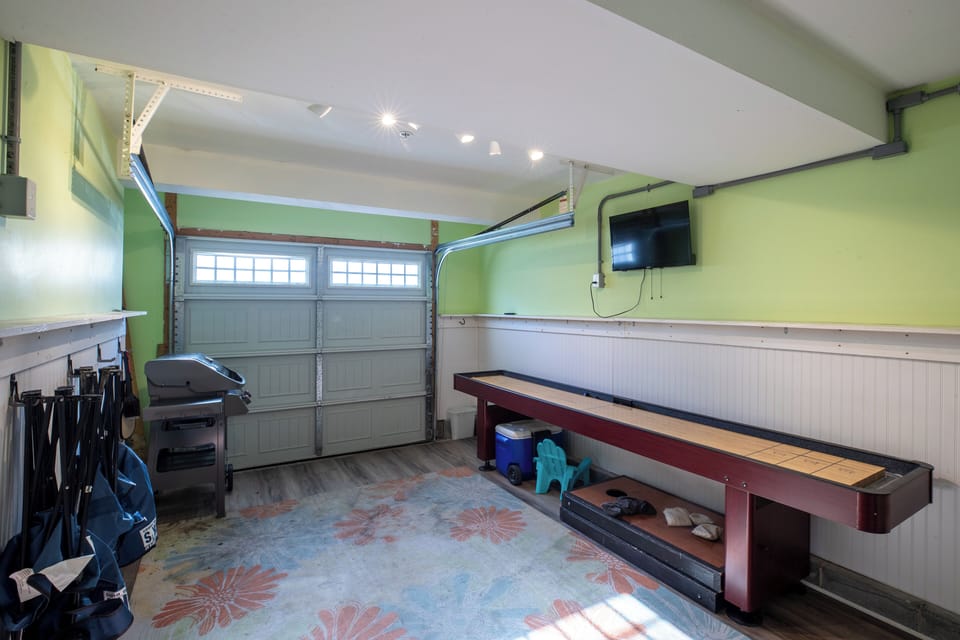 Game room (garage) - darts, shuffle board, tv, cornhole