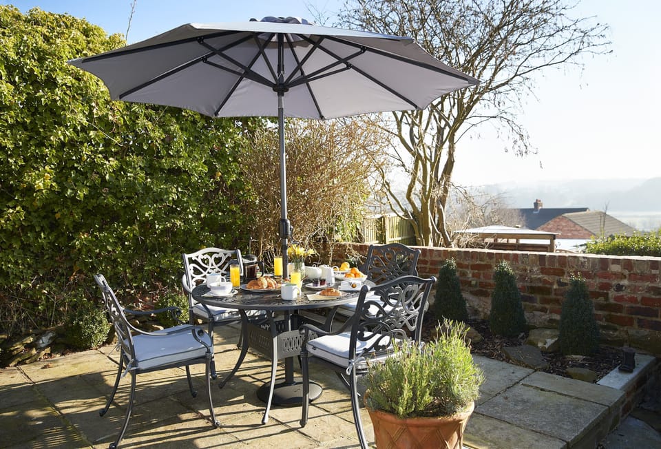 Garden table seating four guests and with spectacular views
