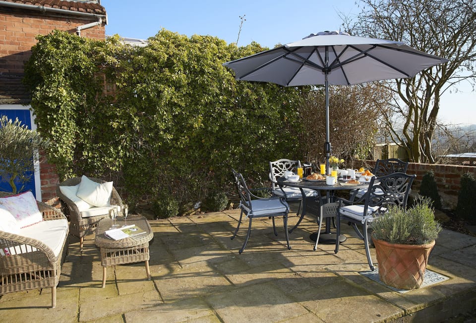 Enclosed patio  garden with two lafuma sun loungers and storage room