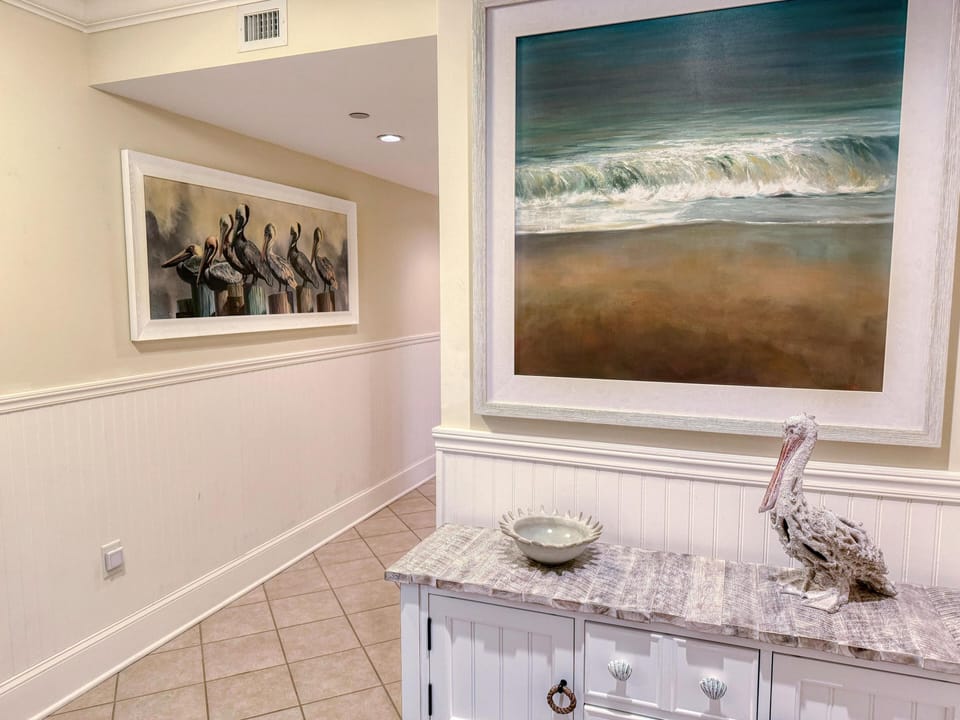 Welcoming entryway with coastal art and charming decor