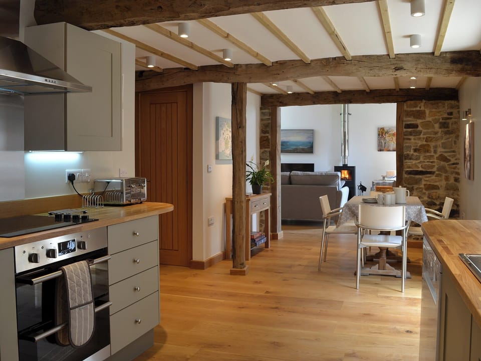 Fully equipped kitchen with open aspect through to the living room | The Oak Stall - Higher Blagrove Farm Cottages, East Worlington, near South Molton