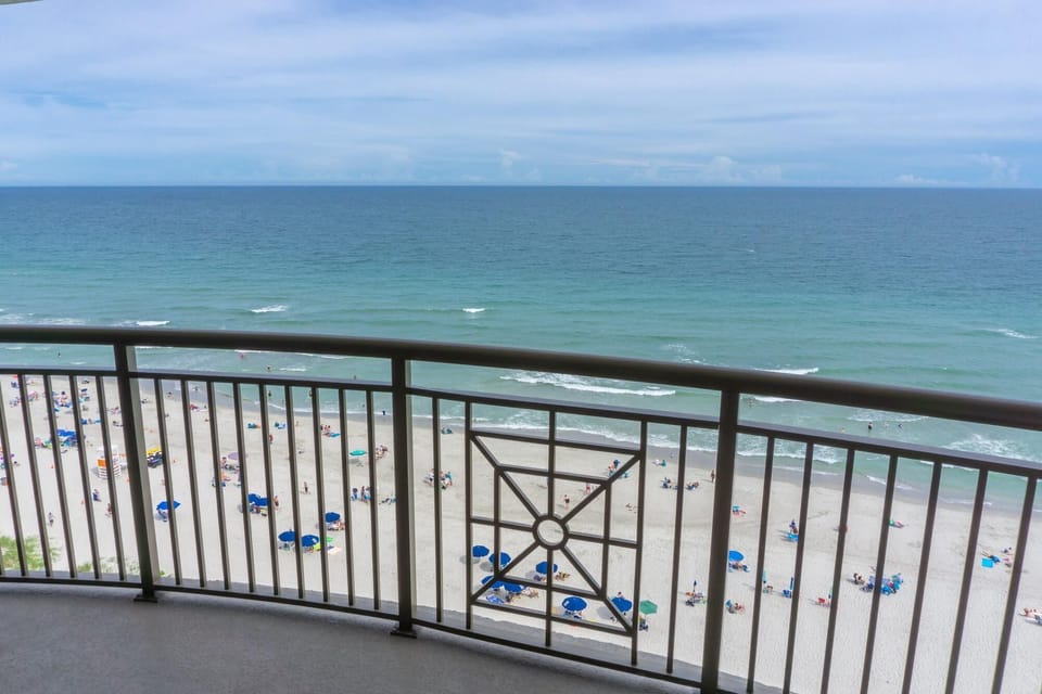 Oceanfront balcony with sweeping beach and water views