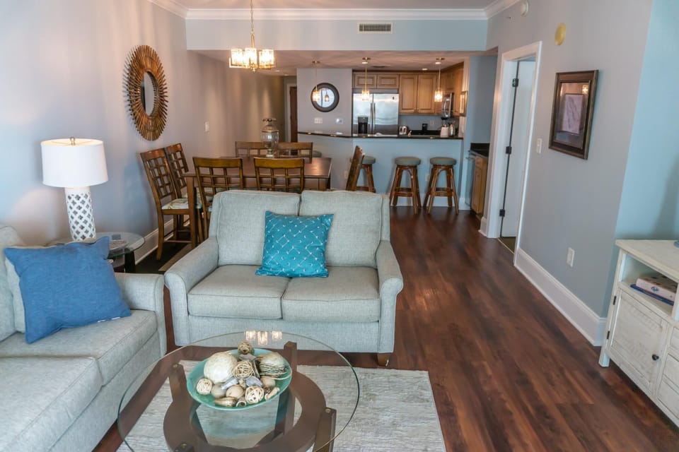 Spacious living room with cozy seating and open kitchen access