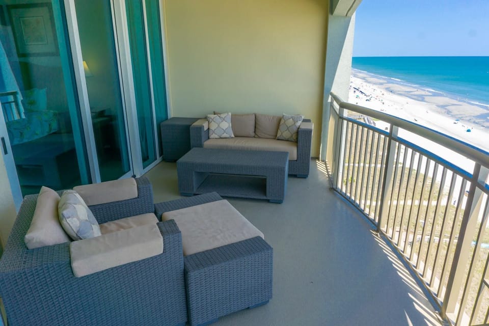 Oceanfront balcony with cozy seating and stunning views