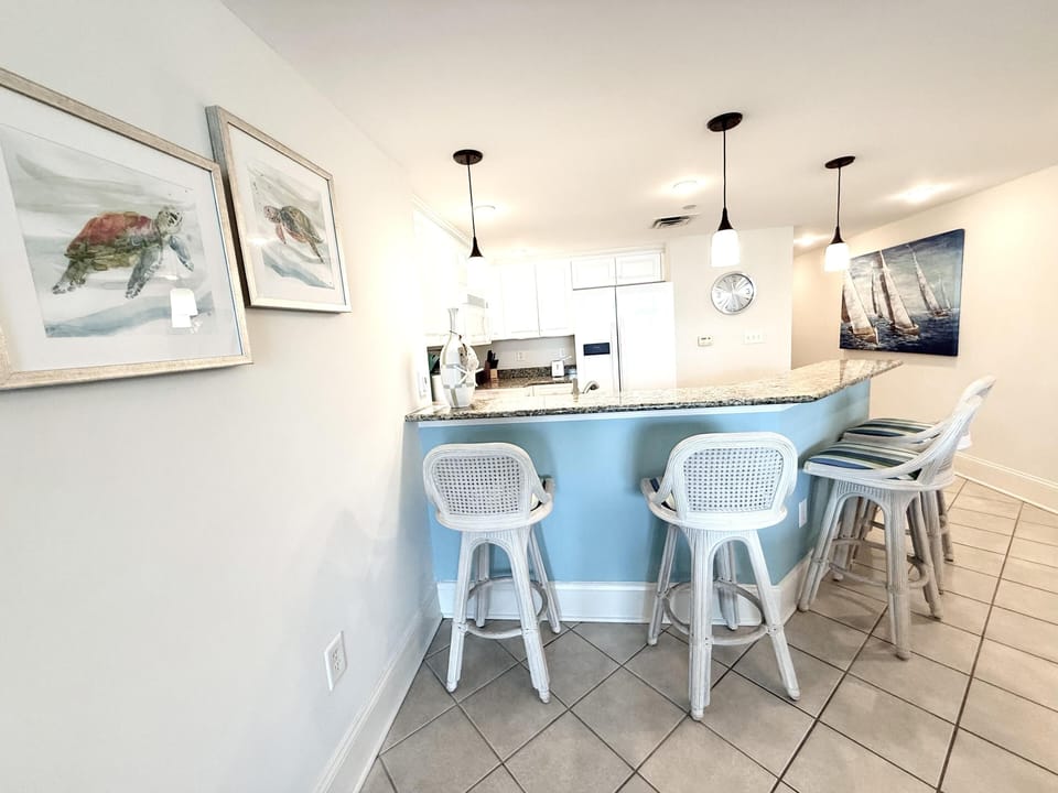 Bright, airy kitchen with cozy breakfast bar seating