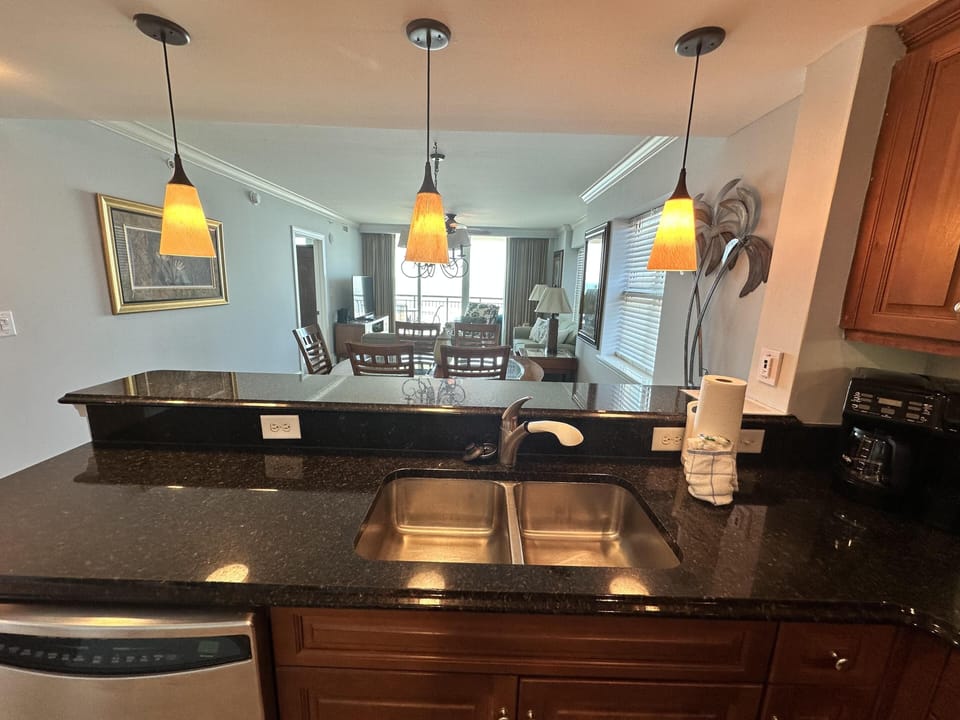 Modern kitchen with sleek granite countertops and warm lighting