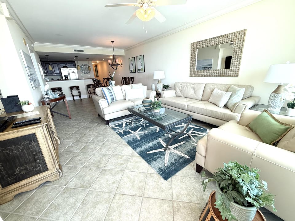 Spacious living room with cozy seating and open kitchen access