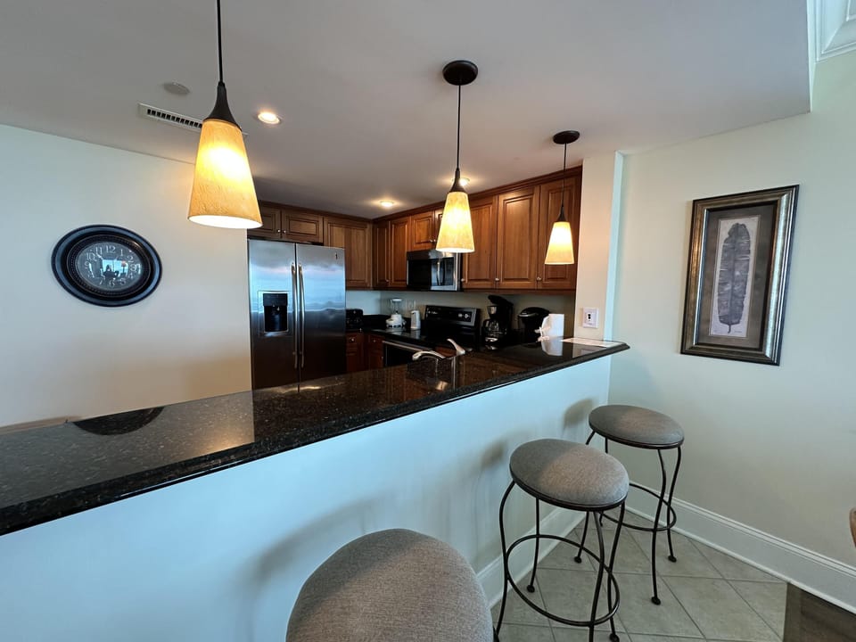 Modern kitchen with cozy breakfast bar seating for three