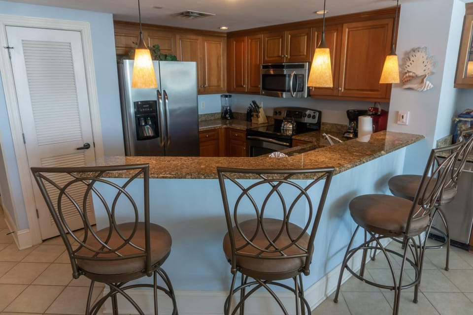 Cozy kitchen with breakfast bar and stainless steel appliances