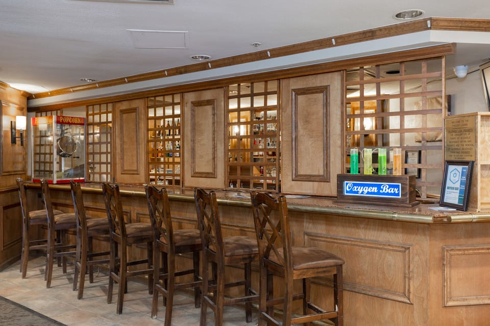 Settle into the elegant wooden bar with classic charm and rich details for your evening drinks and conversations.