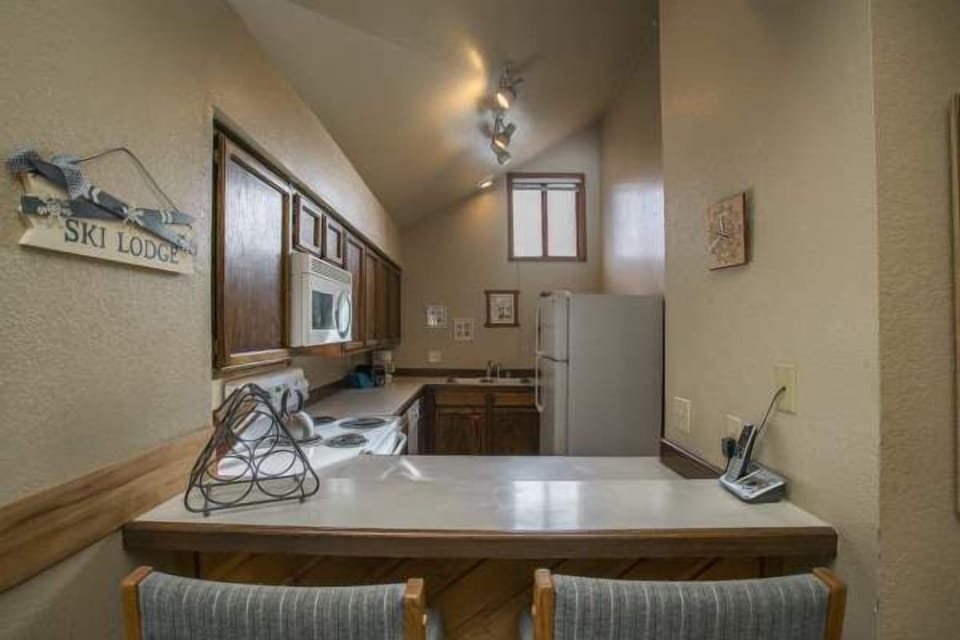 View into kitchen, counter seating.