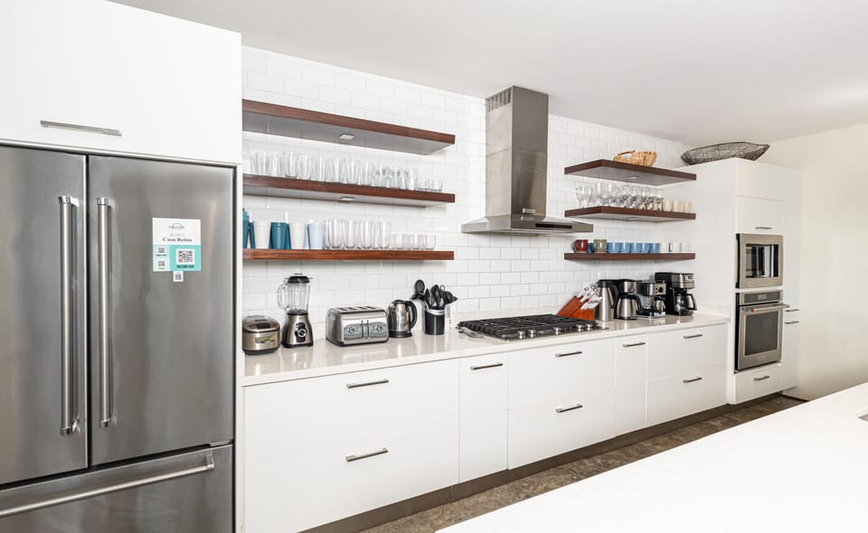 Sleek modern kitchen with stainless steel appliances and open shelving