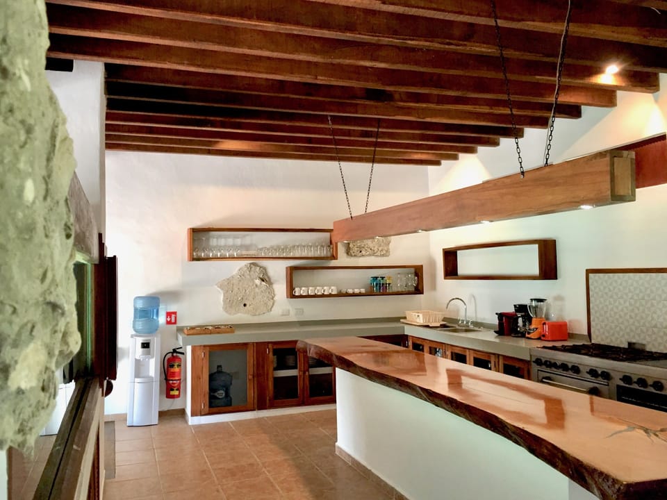 The equipped kitchen has a 6-burner gas stove, oven, flat top, fridge/freezer.
