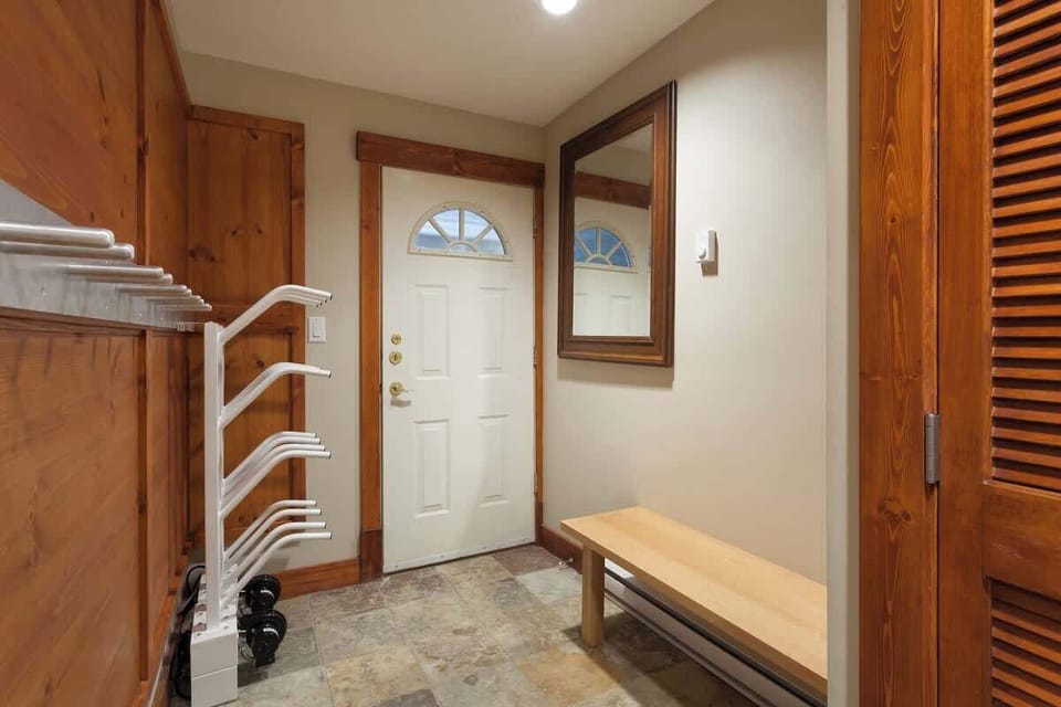 - Inviting mudroom with bench and boot drying racks  
- Ideal Whistler ski cabin entryway for winter gear  
- Organized welcome space with warm wood design  
