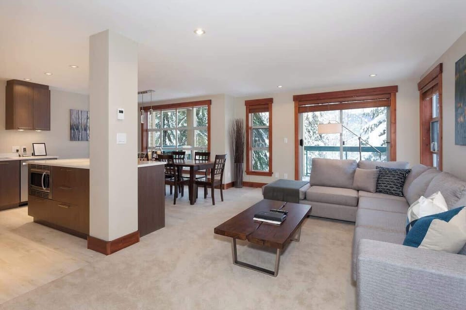 - Modern open-concept living room with scenic snow views  
- Luxury Whistler condo near lifts and village dining  
- Relax in comfort after a day on the slopes  
