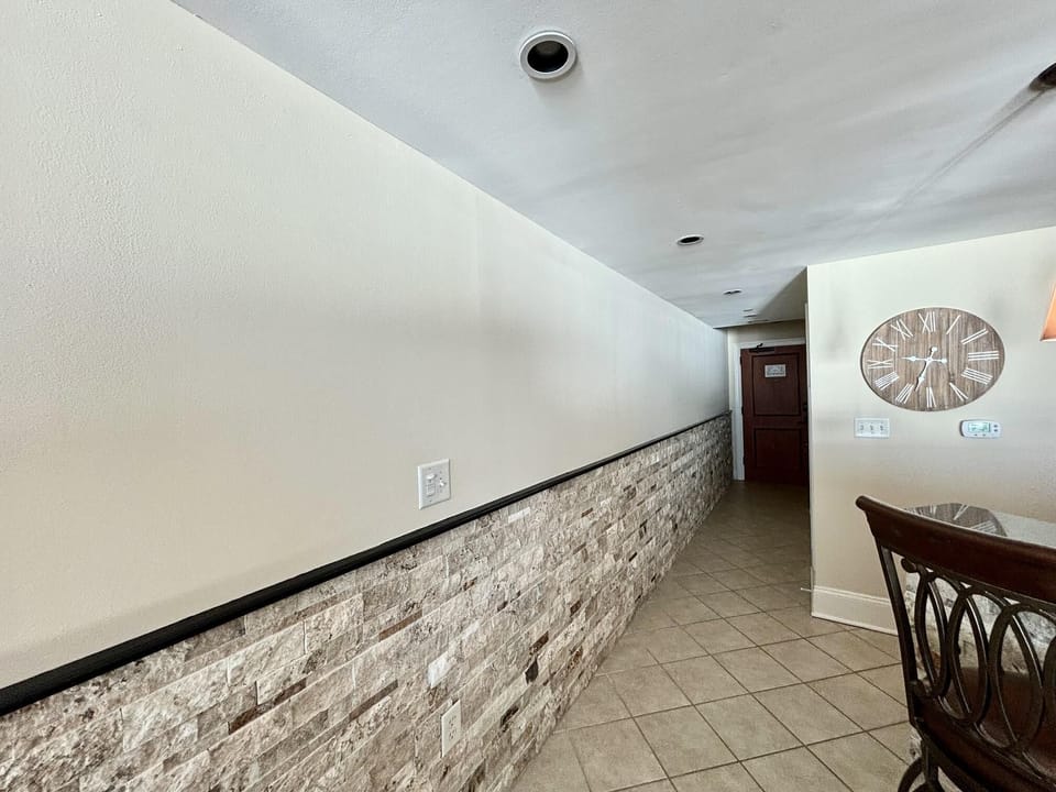 Cozy dining nook with textured stone accent wall
