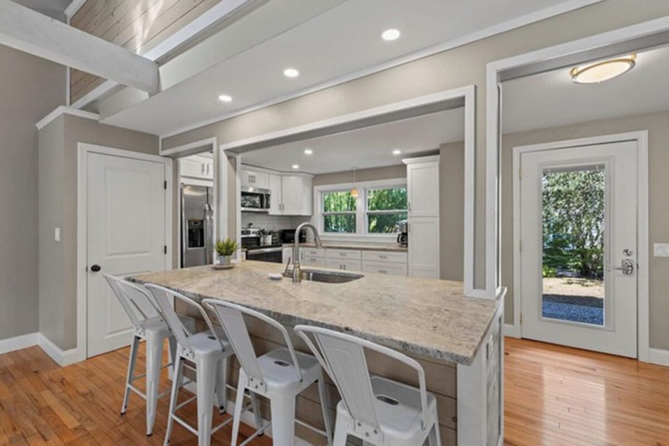 Kitchen features stainless steel appliances and gorgeous quartzite counters