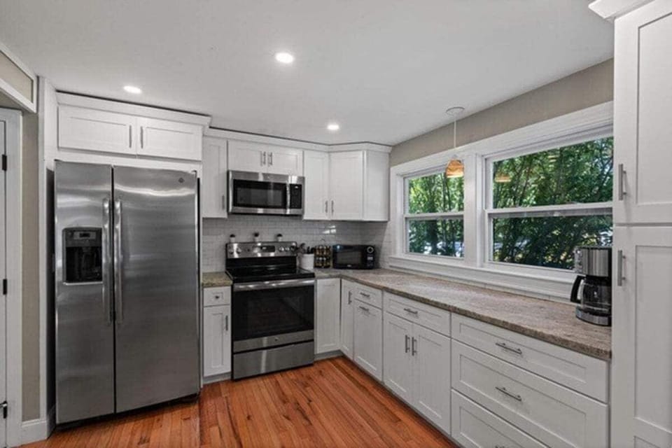 Kitchen features stainless steel appliances and gorgeous quartzite counters