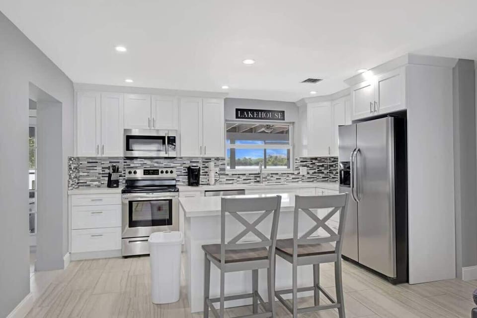 The kitchen is stocked with a full set of appliances including basic kitchen utensils. 